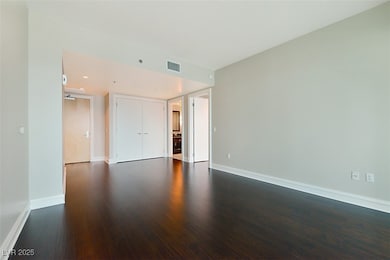 Empty room featuring dark wood finished floors, vi