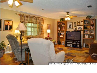 Large den with beautiful laminate flooring.