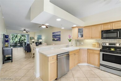Kitchen featuring a peninsula, backsplash, light b