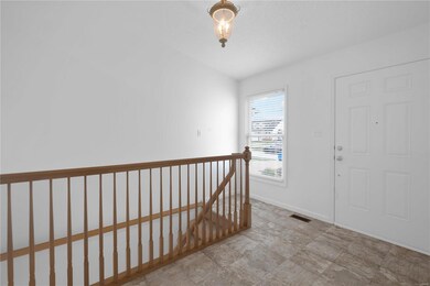 Entry foyer with open staircase to lower level wou