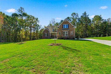 Craftsman house with a front lawn and brick siding