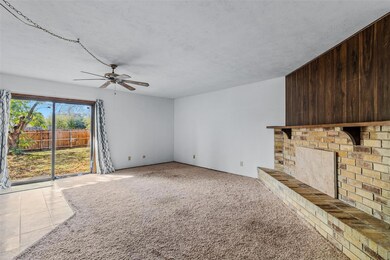 Unfurnished living room featuring a fireplace, lig