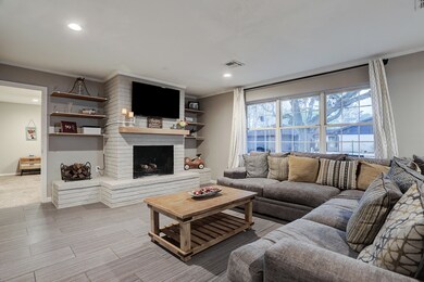 Family room has large windows and is open to the primary bedroom that is downstairs.