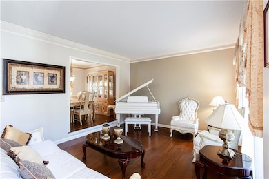 Living room with wood finished floors, baseboards,