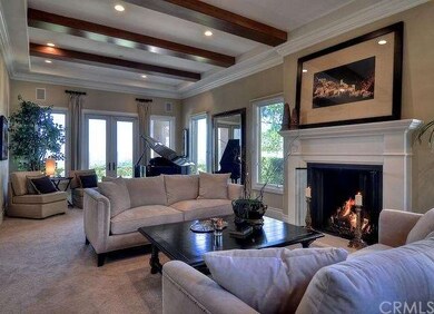 The living room has wood beamed ceilings, crown mo