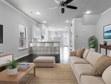 Living area with ornamental molding, a ceiling fan, wood finished floors, and recessed lighting