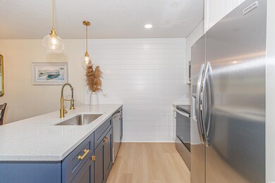 Kitchen featuring blue cabinets, light hardwood / 