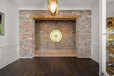 Entryway/ Foyer. Gorgeous brick and beam details add warmth and architectural charm throughout the home.