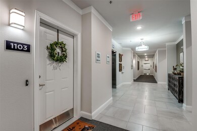 Hallway with crown molding and light tile flooring
