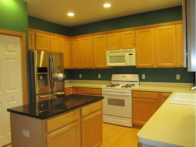 Granite center island, stainless refrigerator