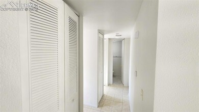 Hallway with light tile patterned floors