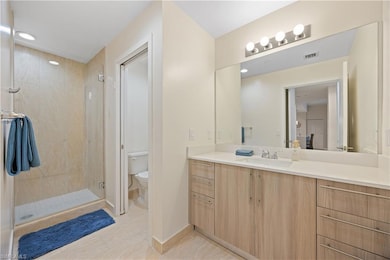 Full bath with a shower stall, vanity, visible ven
