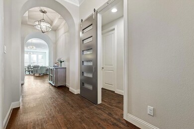 Hallway with barn door that connects two bedrooms 