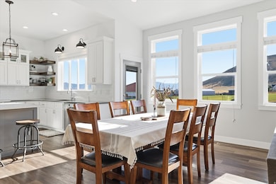 Dining room featuring dark wood finished floors, recessed lighting, and a mountain view