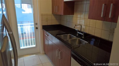 Kitchen with view of balcony.