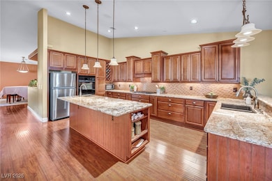 Kitchen with brown cabinetry, light wood-style flo