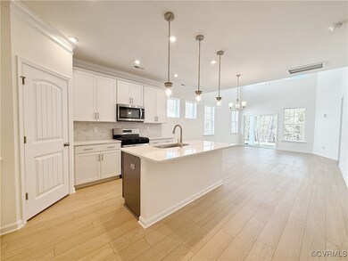 The kitchen which features a center island, quartz