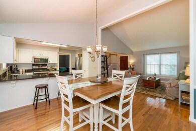 Cathedral ceiling dining room and hardwood floors.