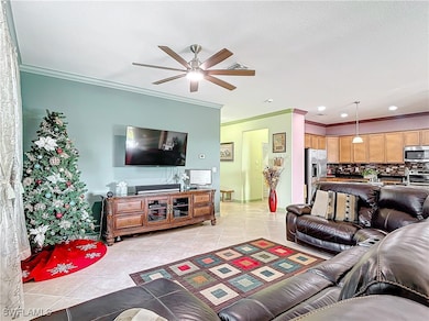 Living area with ornamental molding, light tile pa