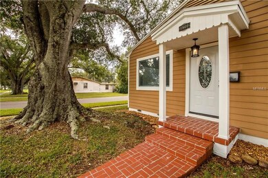 Long brick sidewalk leads to front porch