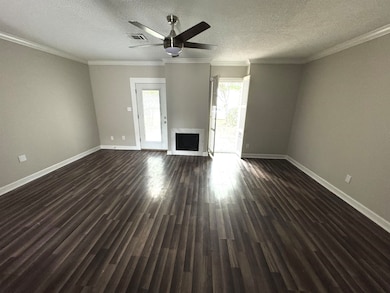 Unfurnished living room featuring crown molding, a