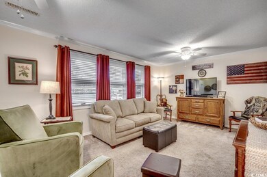 Living room featuring ceiling fan, light colored c