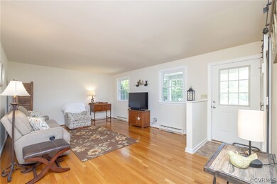 Living room with a baseboard heating unit and ligh