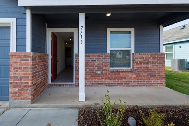 Entrance to property with a porch and central air 