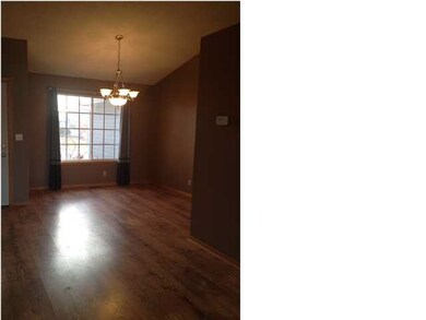 Formal dining area opens up to the living room. Co