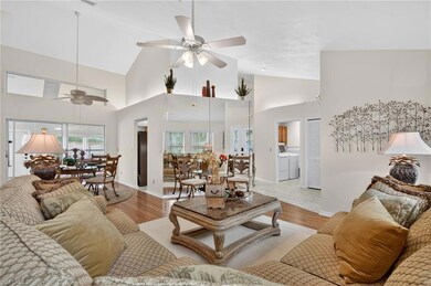 Living area featuring high vaulted ceiling, wood finished floors, and a ceiling fan