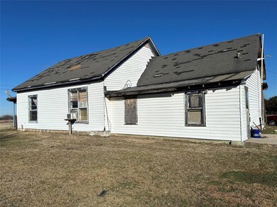 Back of house with a lawn