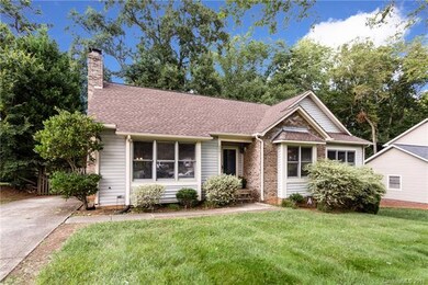 Large flat front yard with a carpet of green grass
