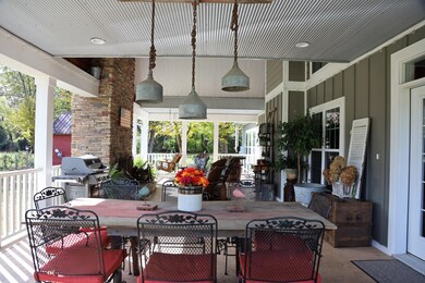Covered rear patio has vaulted ceiling, covered in barn-metal for a rustic feel. Huge fireplace features a stone hearth salvaged from a pre-civil war home in Kentucky. 