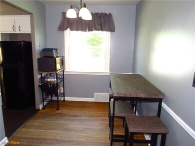 Dining room with hardwood / wood-style flooring and a chandelier