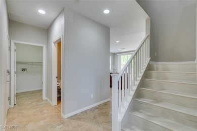Stairway with recessed lighting and baseboards