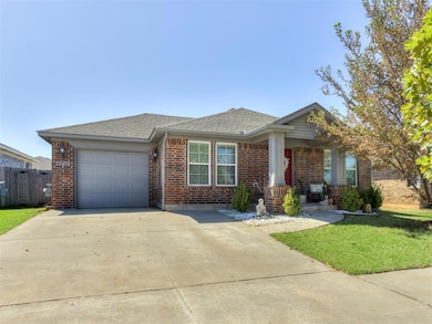 View of front of property featuring a shingled roof, brick siding, concrete driveway, and a garage