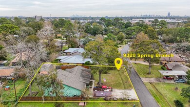You can see the metal roof of a remodeled home nex