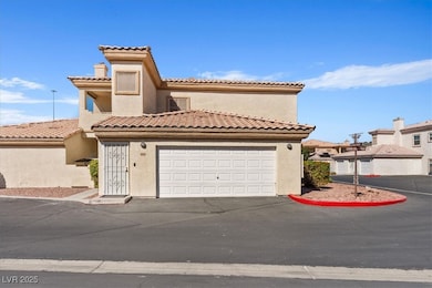 Mediterranean / spanish house with stucco siding, a tile roof, and driveway