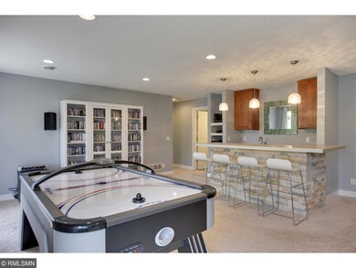 Expansive recreation room with recessed lighting a