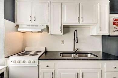 Alternative view of kitchen.  Original Marsh cabinets add to the charming appeal!