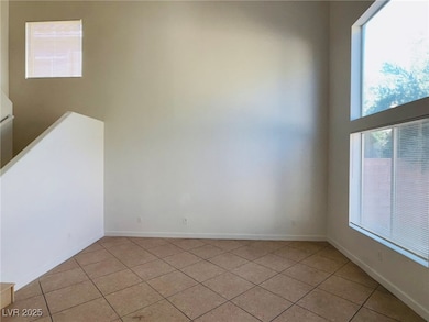 Empty room with plenty of natural light and light tile patterned floors