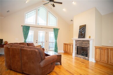 Stone encased gas fireplace with built-in cabinets