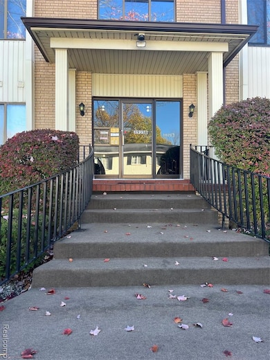 View of exterior entry with brick siding