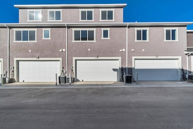 Rear view of property with stucco siding and an attached garage