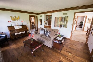 Family room has new wood floors & wet bar.