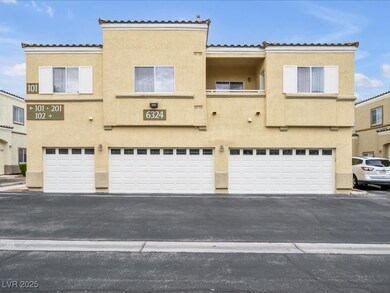 View of property featuring an attached garage, stu