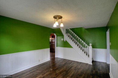 Formal Dining Room showcases beautiful stairway.