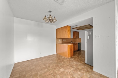 Kitchen featuring brown cabinets, freestanding re