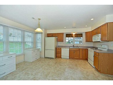 Kitchen. The kitchen features a wall of windows to