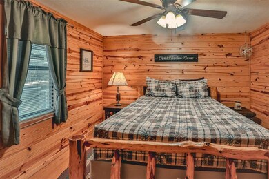 Bedroom featuring wood walls, a textured ceiling, 